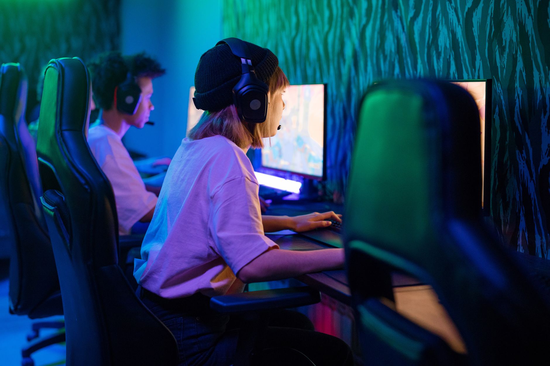 Young gamers deeply focused on an intense gaming session in a high-tech esports arena.
