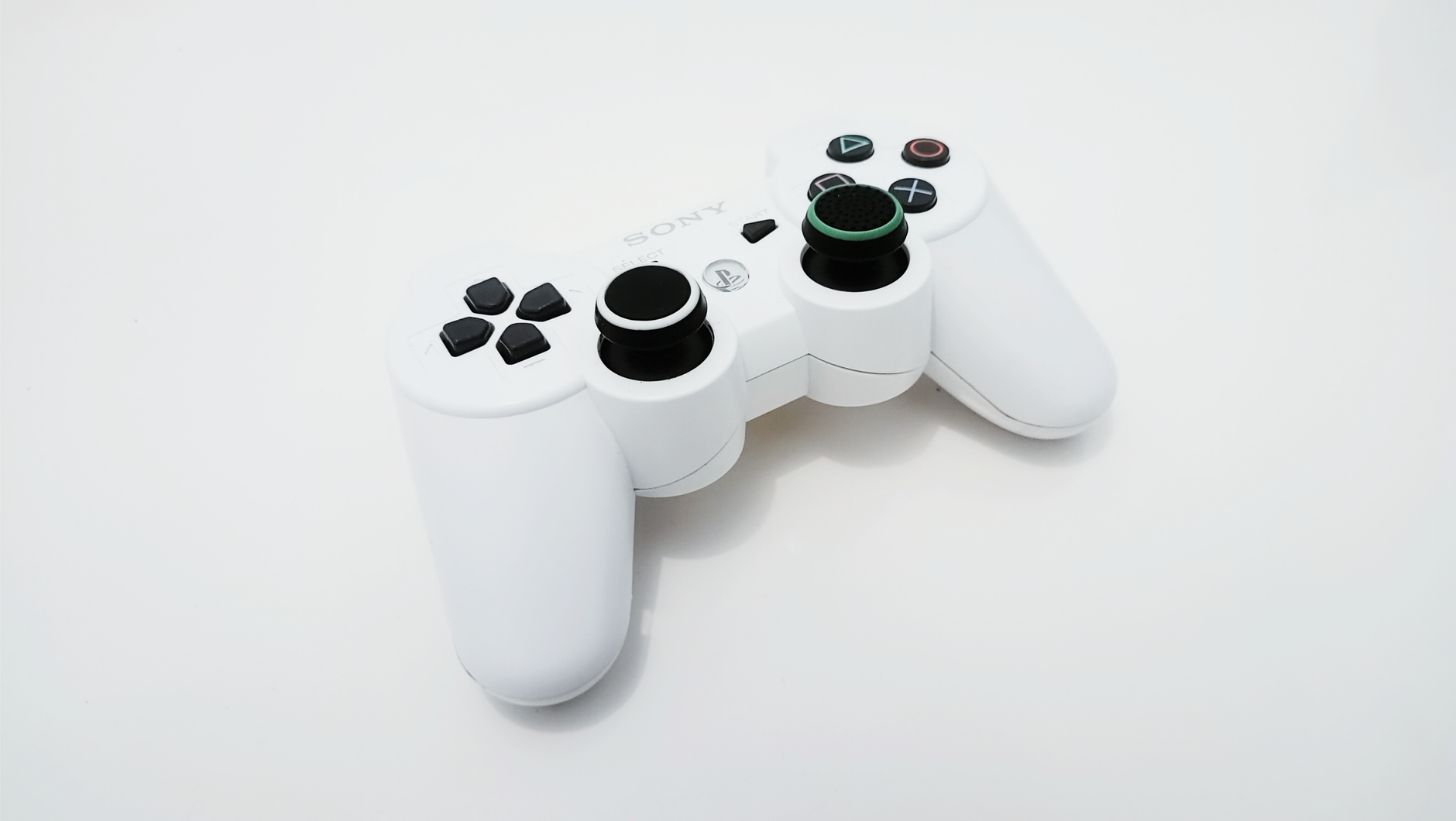 Close-up of a white gaming controller, ideal for PlayStation console enthusiasts.