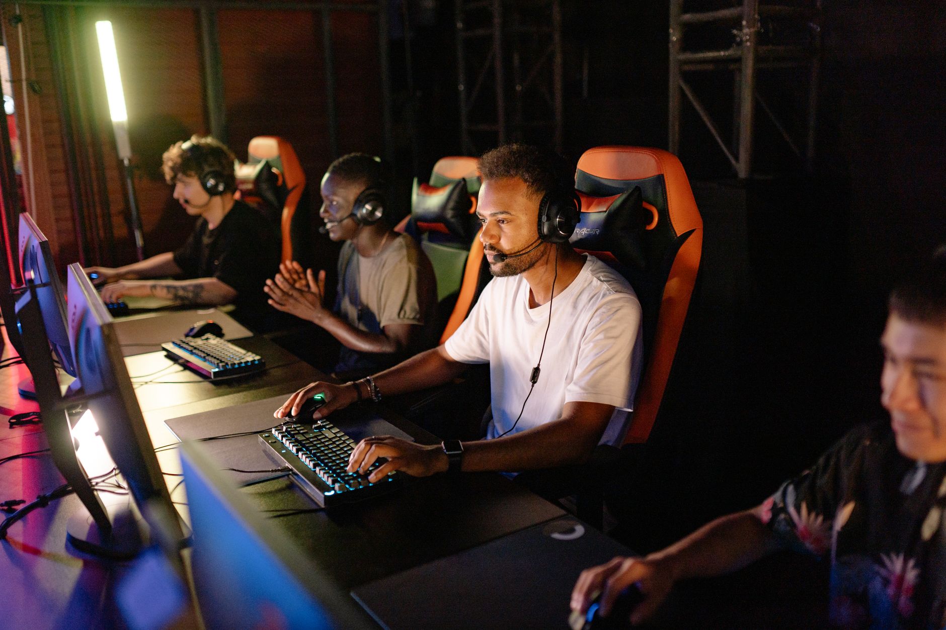 A group of young adults intensely focused on a competitive esports tournament indoors.