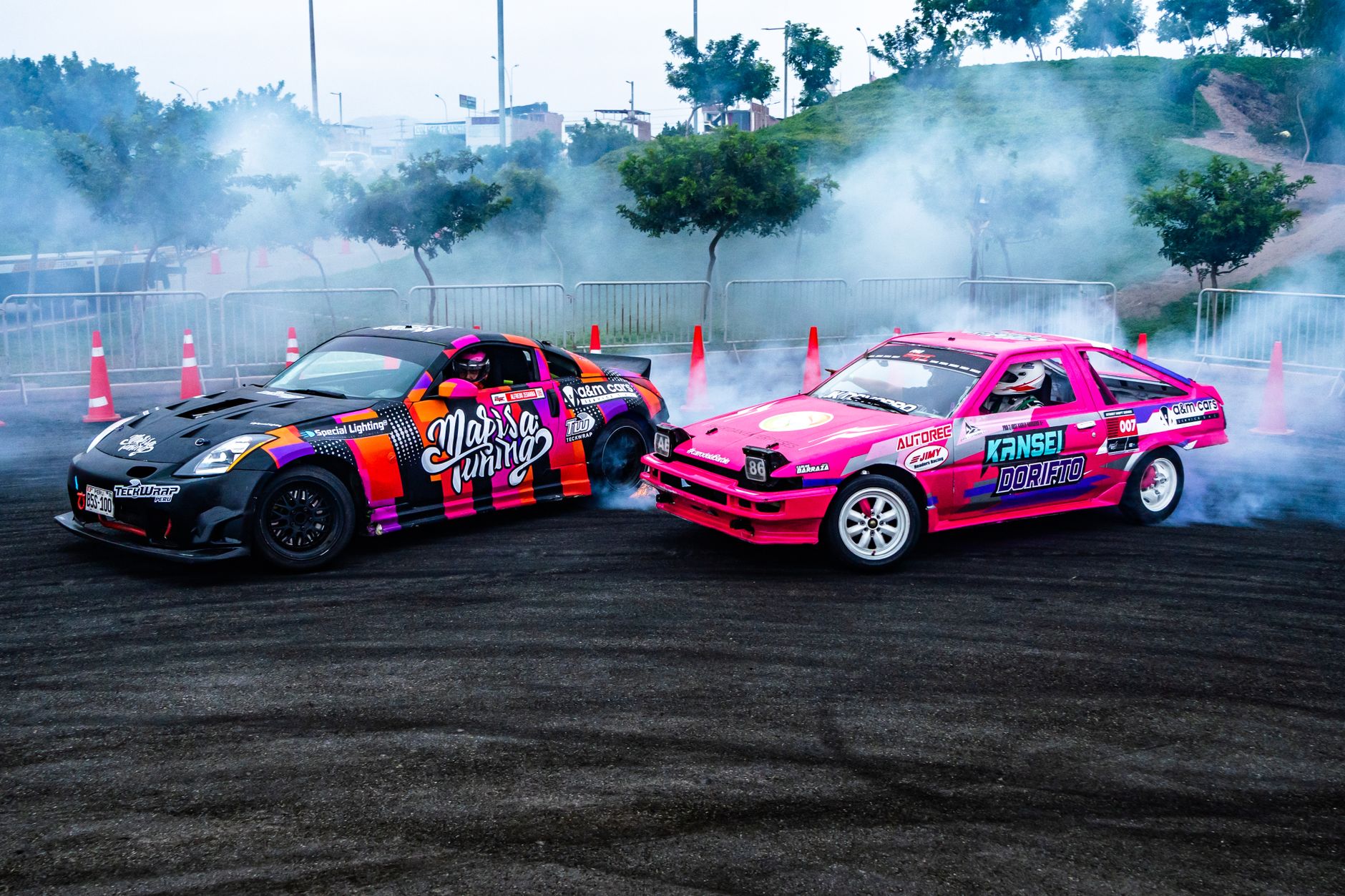 Dynamic scene of colorful drift cars racing on asphalt with smoke and fog in a racing area.